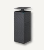 Angled view of the dark grey Coway Noble Air Purifier (AP-2021A) with its top pop-up vent elevated, highlighting its award-winning architectural tower design.