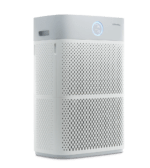 Side quarter view of the white Coway AP-3018B Ultra Air Purifier, showing the large dual-side air intake grills and the circular smart status display.