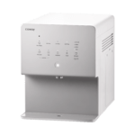 Wide lifestyle view of the white Coway CHP-6330L countertop water purifier placed on a modern kitchen counter with white tiles, showcasing its elegant and space-saving design.