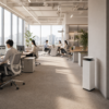 Coway Airmega ProX AP-2023K air purifier installed in a modern open-plan office with white tower design and dual-engine filtration.