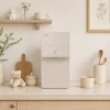 Coway Prime Water Purifier P-6320L in beige, a slim countertop reverse osmosis system styled in a modern kitchen with warm aesthetic decor.