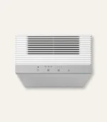 White wall-mounted mini-split air conditioner unit with horizontal vent slats and a gray control panel on a light background