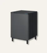 Tall dark gray Coway air purifier with vertical fins and a blue status light on the top front edge.