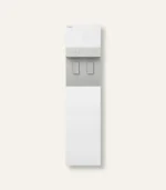 White Coway water purifier and dispenser with two taps on a light gray panel, standing against a pale beige background.